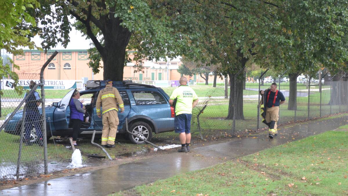 CRASH: The Holden Commodore appears to have slid through the fence into the tree.