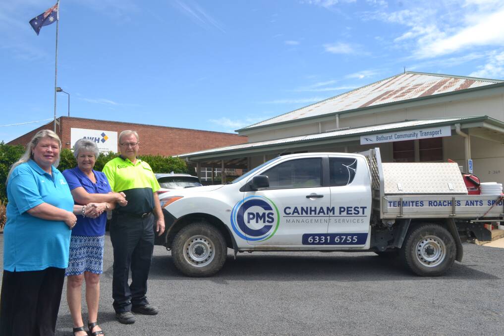 SUPPORT: Di Canham, Leonie Schumacher, from Bathurst Community Transport and Mick Canham shake hands after a $3,500 donation from the Canham family's business, towards the Radiation Bus.