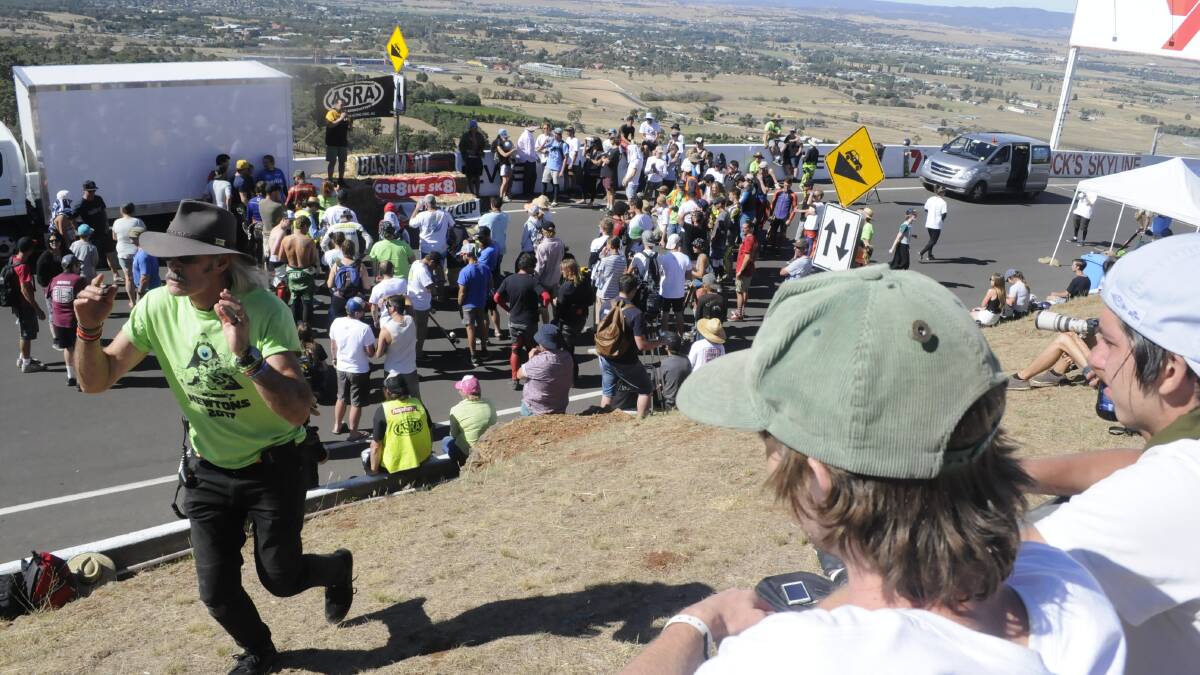 NEWTON'S: Spectators and competitors gather for the post race presentations at Brock's Skyline, Mount Panorama.