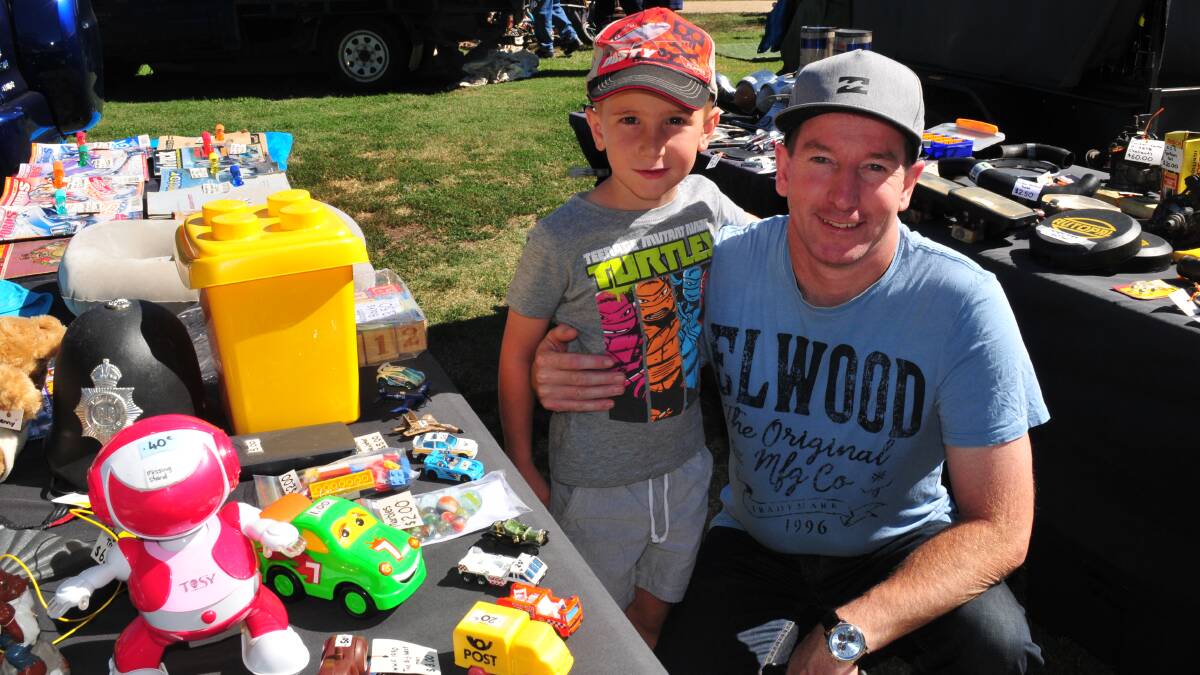 SWAP MEET:  Aston Robson, 6, with his dad Heath Robson at the swap meet. Aston was checking out toys for sale. 