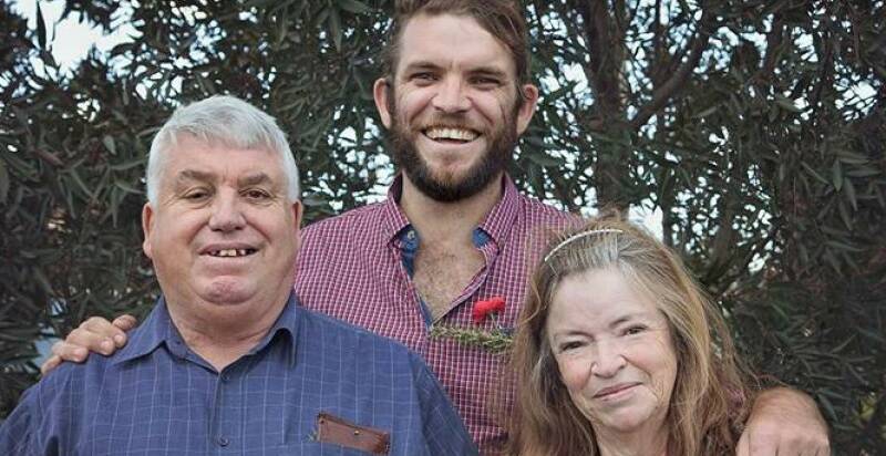 FAMILY: Neil Kearney (centre), who remains in a critical condition at Royal Prince Alfred Hospital, with his mother and father, John and Robyn.
