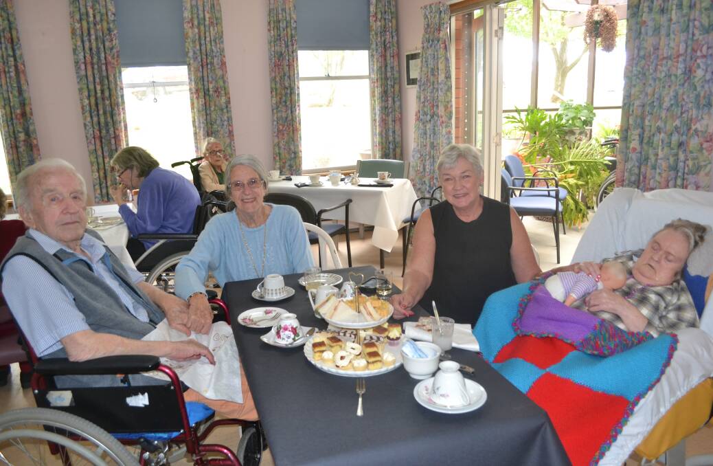 IN THE PICTURE: Bill and Carmel Melton enjoying the high tea with Elaine Hawkey and her sister Christine Cox.