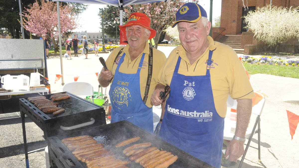 BBQ: Bathurst Macquarie Lions Club members, Dennis Coopes and Pat Duff  cooked over 1000 sausages at the drivers autograph session, on Wednesday. 100417cv8fans7