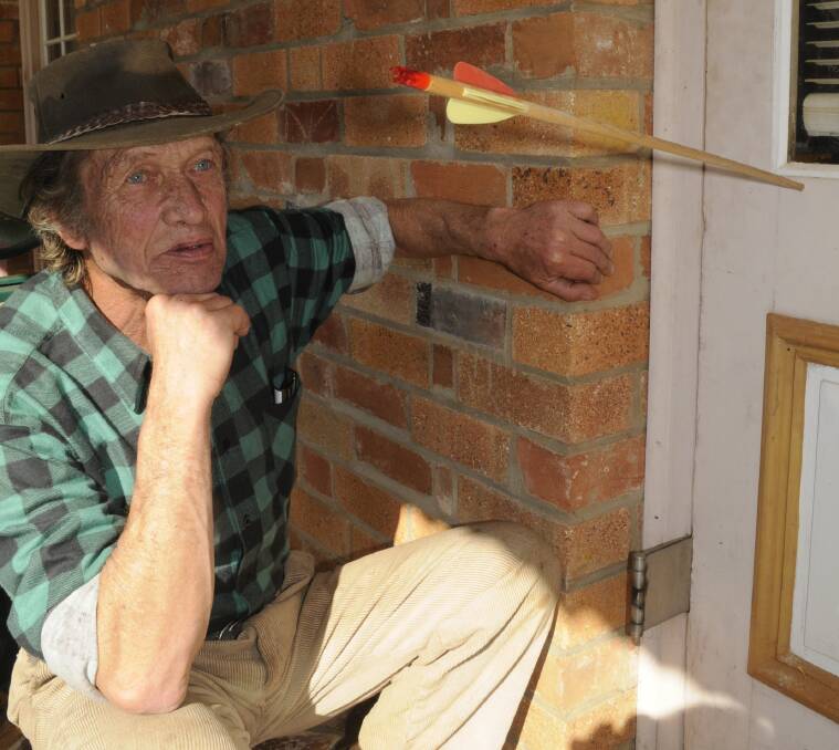 ON TARGET: Carlo Jensen with the arrow lodged in his front door. Photos:CHRIS SEABROOK 081516carrow2