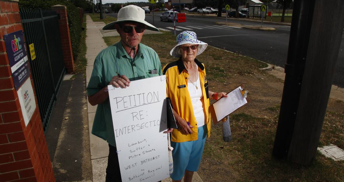 TIME TO ACT: Kent and Dianne McNab standing out the front of The Assumption School petitioning for changes to the nearby intersection at Suttor and Mitre streets.