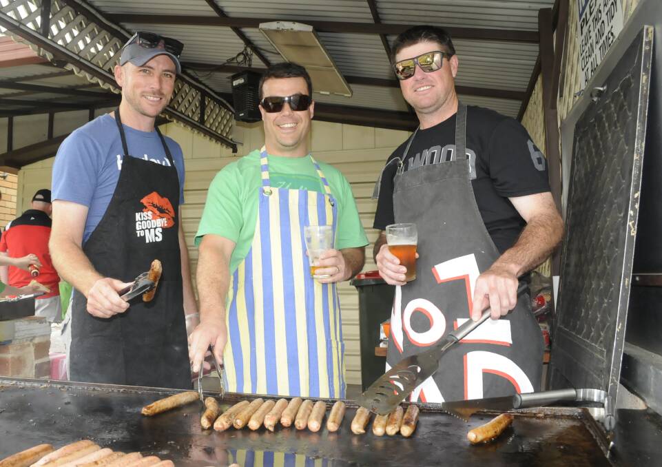 COOKING UP A STORM: Left, Damian Fulthorpe, Aaron Bateup and Adrian Henry manned the barbecue during the fundraising event. 103016cms2a