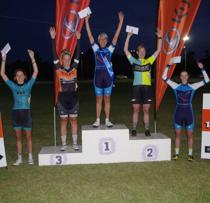 CHEERING: Bathurst Cycling Club's Rosemary Hastings stands atop the podium after taking out the Women's Wheel Race at the Goulburn Track Carnival. Bathurst's Brooke Tuynman (right) was fourth. Photo: DARRYL FERNANCE