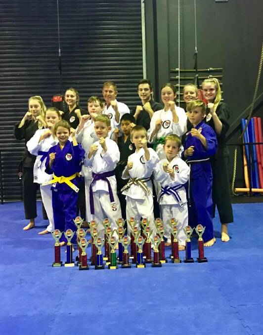 GREAT HAUL: The Precision Martial Arts tournament team who competed at the ACT State Championships. The group picked up 13 victories against over 400 competitors at the Australian institute of Sport.