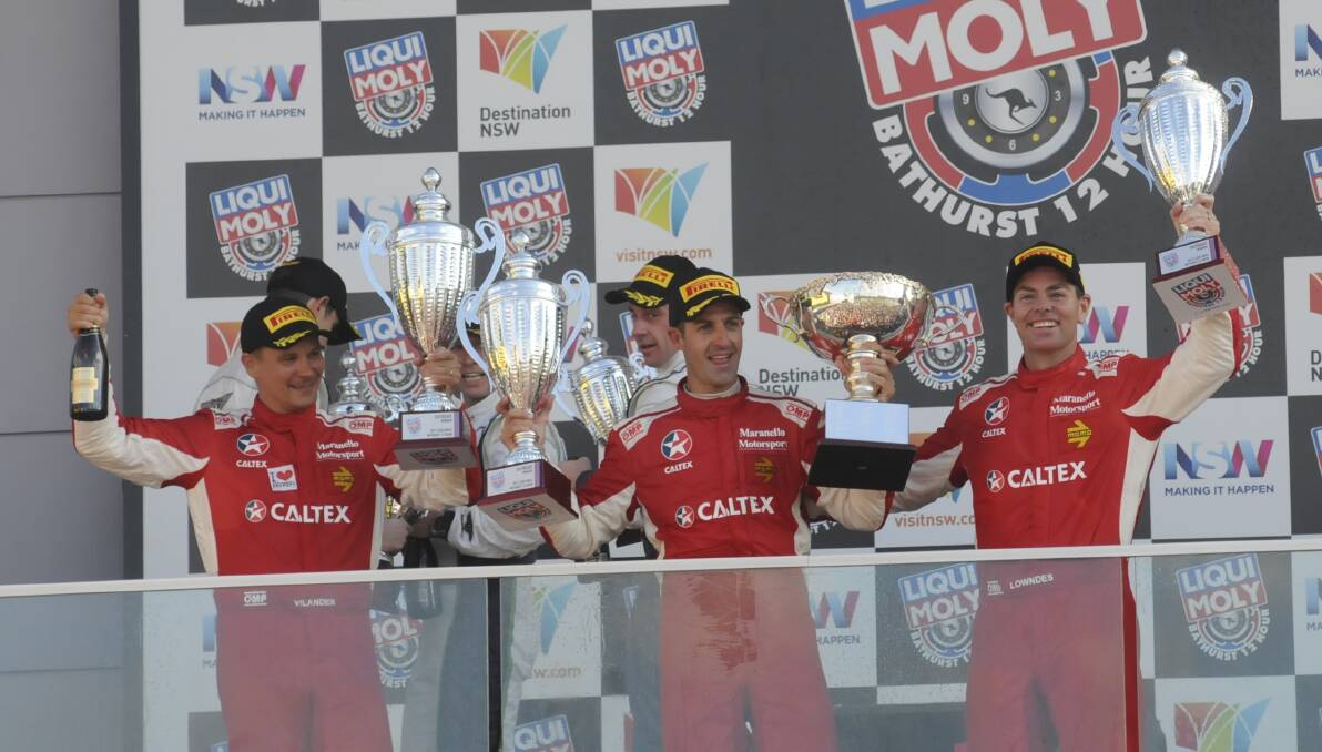 CHEERING: Toni Vilander, Jamie Whincup and Craig Lowndes celebrate their Bathurst 12 Hour victory. Photo: CHRIS SEABROOK