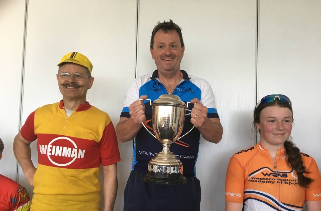 FIRST CLUB WIN: David Hyland displays his prize following Sunday's Remember Them Trophy Race. John Kitchen and Eliza Bennett filled the minor placings at the end of the 26km race. Photo: MARK SIMONS