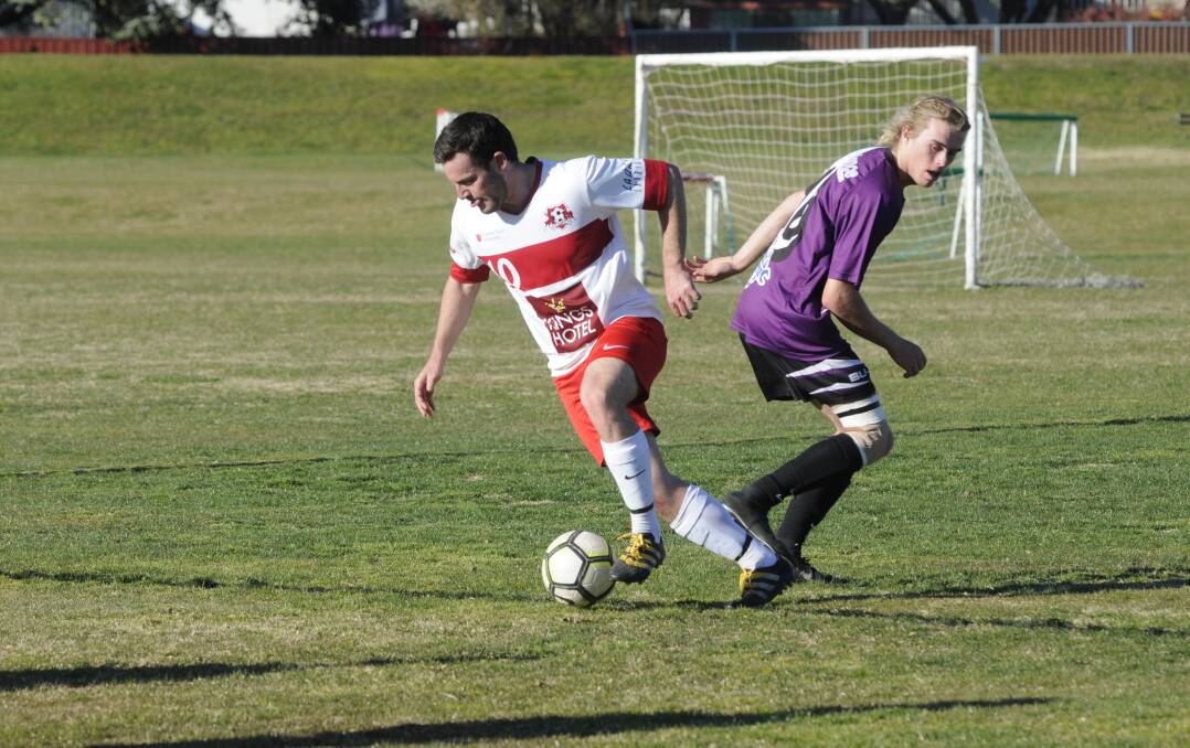 BYE BYE: Benjamin Green gets by an opponent during Sunday's Bathurst District Football men's Premier League semi-final. Photo: CHRIS SEABROOK 091017csusocr1