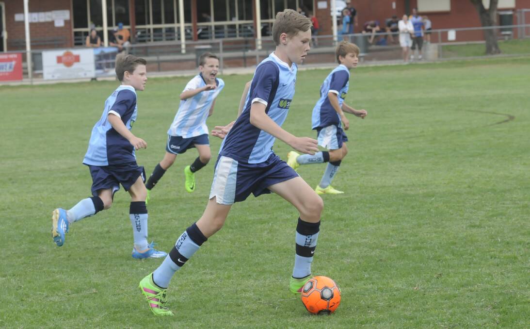 DRIBBLE: Bathurst under 13s player Ji Hartland takes the ball forward in his side's match against Sutherland AYL. Photo: CHRIS SEABROOK 030417csocr2