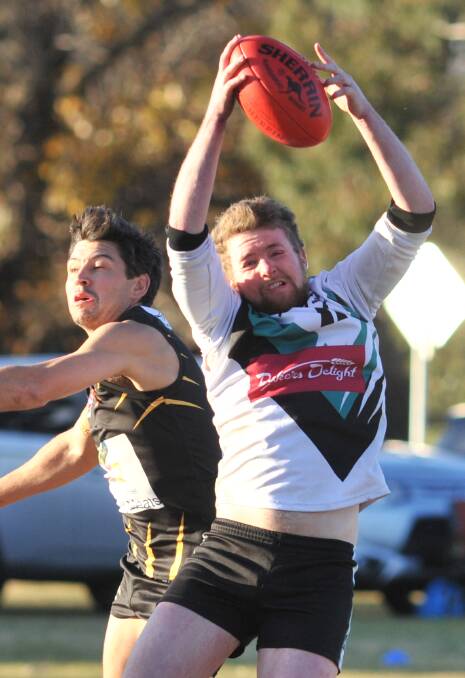 ONE POINT IN IT: Bathurst Bushrangers Rebels' Matt Griffin goes up for the ball in Saturday's thrilling contest against the Orange Tigers. Photo: JUDE KEOGH