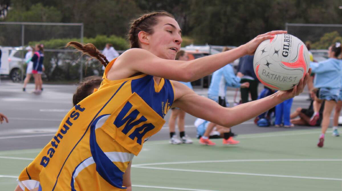 CHAMPIONS: Bathurst Netball Association's Carina Floyd grabs a pass during her side's win over Hawkesbury. Photo: CONTRIBUTED