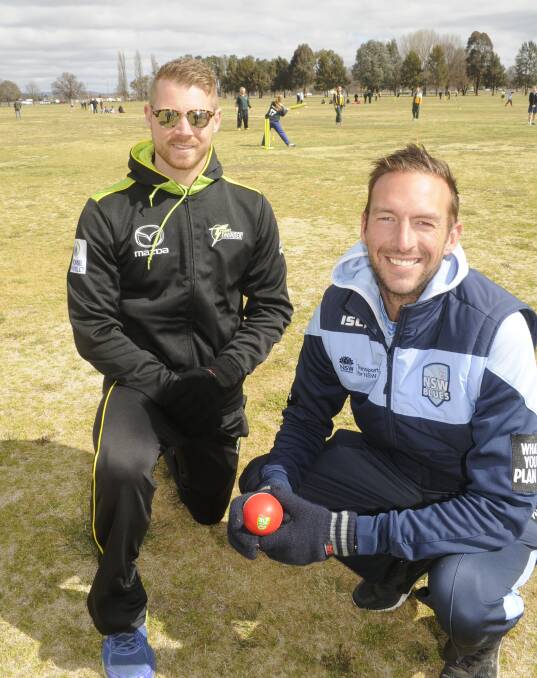 HELPING HAND: Sydney Thunder squad member Nathan McAndrew and Bathurst test cricket product Trent Copeland were in the city on Wednesday. Photo: CHRIS SEABROOK