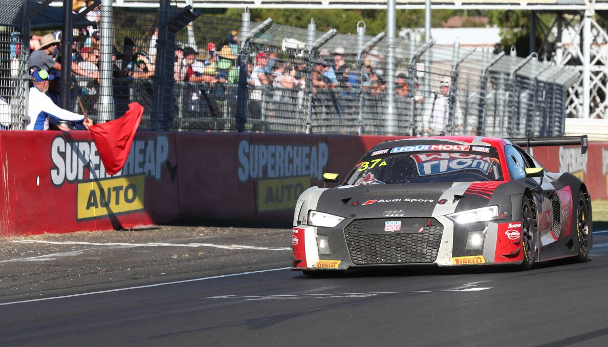 FINISHED EARLY: Robin Frijns drives his Audi across the line as the red flag is waved in Sunday's Bathurst 12 Hour. Photo: PHIL BLATCH