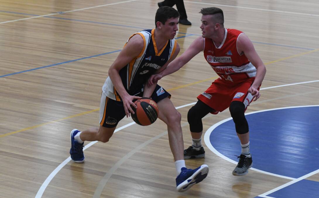 SLOW START: Bathurst Goldminers' Matt Gray searches for a path for the Illawarra Hawks' defence on Saturday night. Photo: CHRIS SEABROOK