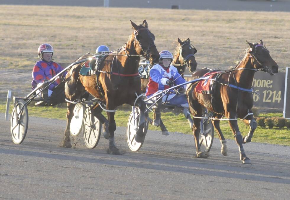 HERE I COME: Amanda Turnbull and Dream To Share (right) begin to pull ahead of Bernie Hewitt and Taylor Hood (left) to take out the Club Menangle Where Horse Fly Heat One (1,730 metres) at Bathurst Paceway. Photo: CHRIS SEABROOK
