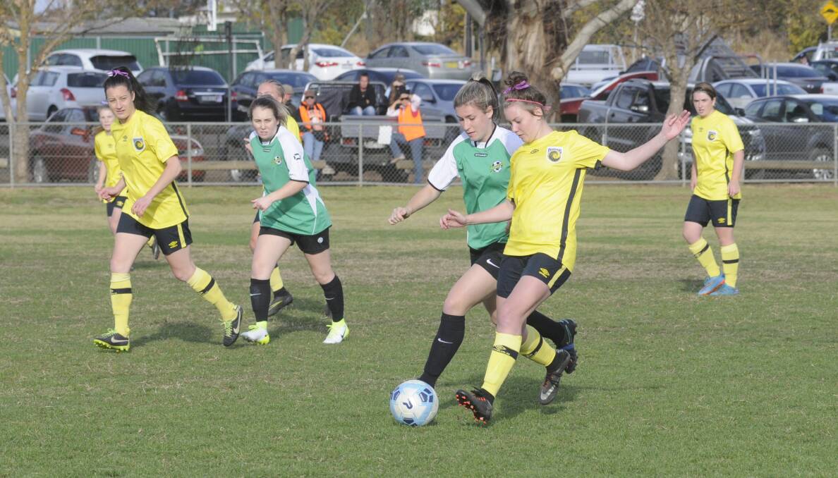 TUSSLE: Western NSW Mariners FC's Sarah Morris contests for possession with a Mount Druitt Rangers FC opponent on Sunday. Photo: CHRIS SEABROOK 051417cgmarin1