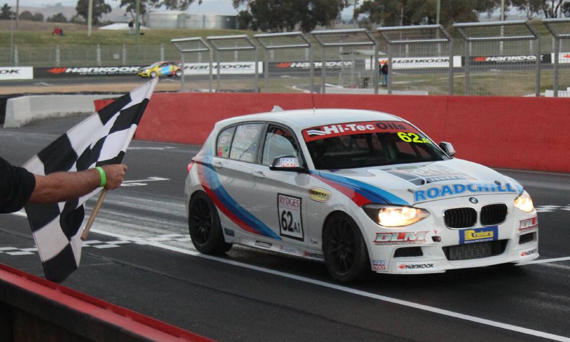 VICTORY: Luke Searle receives the chequered flag in Sunday's Bathurst 6 Hour. Photo: PHIL BLATCH G83G9328