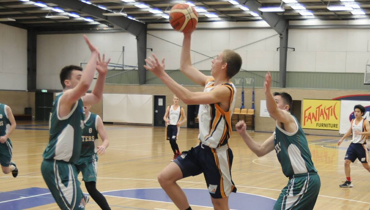 CLUTCH: Kobe Mansell goes up for a shot in the Bathurst Goldminers' match against the Newcastle Hunters on Sunday. Photo: CHRIS SEABROOK