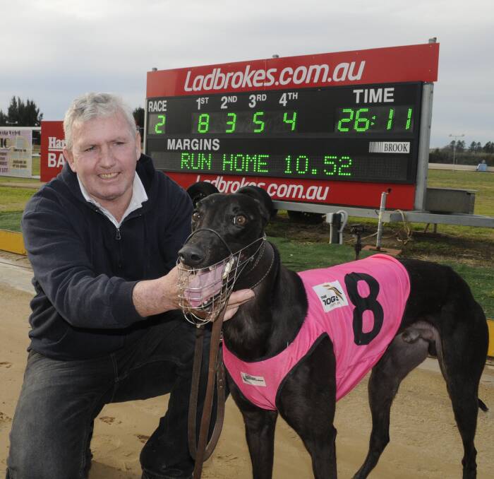FIGHTBACK: Orange trainer Steven Jones with his winner Local Bloke at Kennerson Park on Monday. The runner edged his way ahead of True Danger to earn the victory. Photo: CHRIS SEABROOK 082916cdogs2a