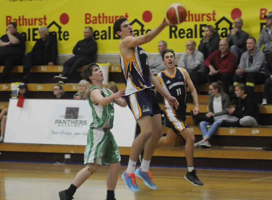REACHING OUT: Bathurst Goldminers' Matt Gray goes up for a shot in his team's crucial win over the Moss Vale Magic on Saturday night at the Bathurst Indoor Sports Stadium. Photo: CHRIS SEABROOK 052017cgoldm1b