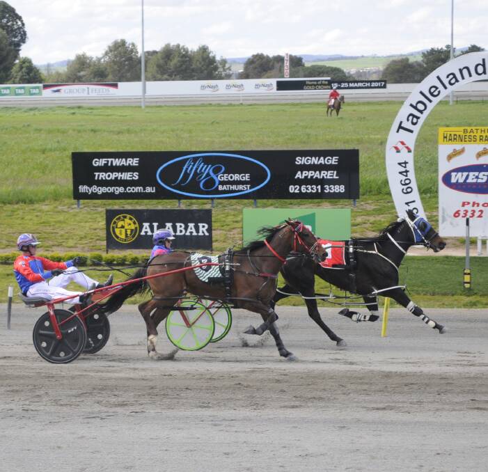 HELD ON: Jess Prior on Arcachon holds off Nathan Turnbull and Folk Art to win at Bathurst Paceway on Monday in the Tab.com.au Consolation (2,260m). Photo: CHRIS SEABROOK 100316ctrots1