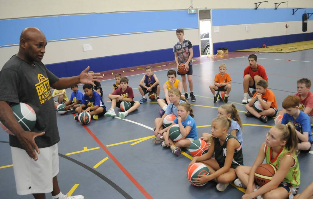 WISE WORDS: Cal Bruton tells stories of his playing days to children during his basketball clinic at Bathurst PCYC on Wednesday. Photo: CHRIS SEABROOK