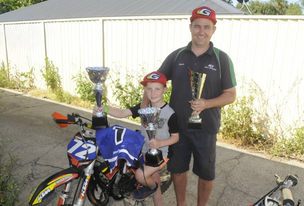 YOUNG GUN: Bathurst's Damien Grabham with his son Noah, 8, who has won four state titles this year. Noah Grabham won both his categories at Victoria and South Australia's championships. Photo: CHRIS SEABROOK