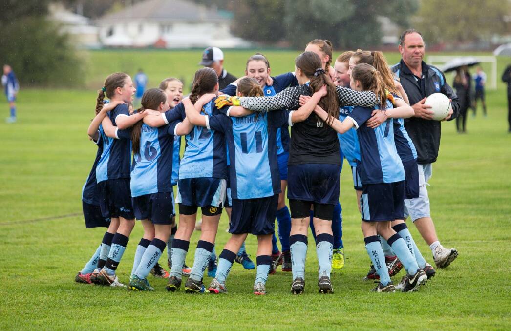 WE DID IT: The Bathurst Under 12s girls side celebrate after beating South Western Sydney 1-0 at Proctor Park on Sunday. Photo: J BALDWIN PHOTOGRAPHY 092116under12s