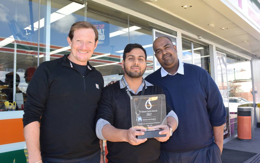 WINNING COMBINATION: 7-Eleven Kelso store manager Vikas Panwar (centre) and franchisees Paul Stevens and Peter Nath with their award. Photo: RACHEL FERRETT