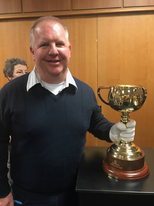 HIGH HOPES: Mick Whittaker could be holding the Melbourne Cup trophy again if the horse he and his wife own shares in wins the race next week. Photo: SUPPLIED