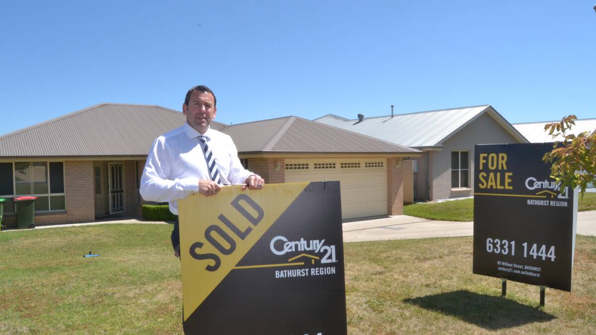 IT'S GONE: David Chapman, from Century 21, with one of the properties sold by the real estate during November, which has been a record sales month. Photo: JACINTA CARROLL