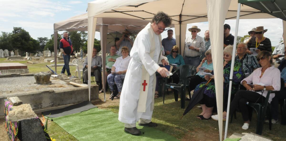 SNAPSHOT: Father Paul Devitt was asked to bless the grave of Beatrice Ethel Grimshaw at Bathurst Cemetery. Photo: CHRIS SEABROOK 011117cgrave4
