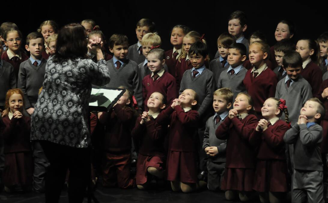 TEAM EFFORT: Teacher Anne Murdoch with Year 1 and Year 2 students from St Philomena's School reciting 'Hey God, about that Baby!', which saw them place first in their section.  Photo:CHRIS SEABROOK 083116ceist1