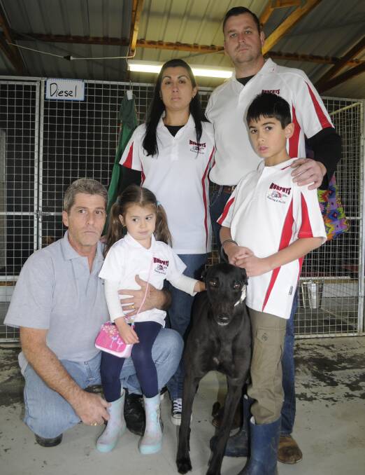 TOUGH: Trainer Matt Murphy (top right) with his father-in-law Daryl Barrett, wife Naiomi, children Khali and Kyle and greyhound Annabelle. Photo: CHRIS SEABROOK 071016cdogs1