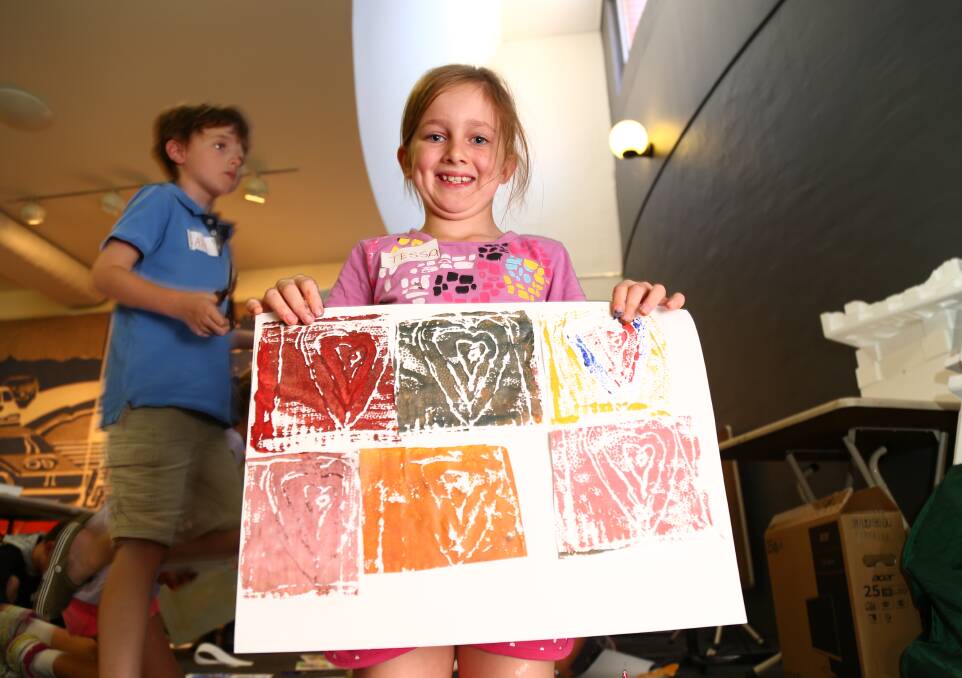 PROUD AS PUNCH: Tessa Wiggins shows off her great creations from a school holiday workshop at Bathurst Regional Art Gallery (BRAG) last week. Photo: PHIL BLATCH 041818pbart1