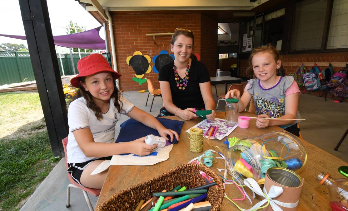 GOOD FUN: Zoe Cunningham, 11, educator Ella O'Dell and Tamsyn McCabe, 10, making bags and snow globes. Photo:CHRIS SEABROOK 012218cvacare1