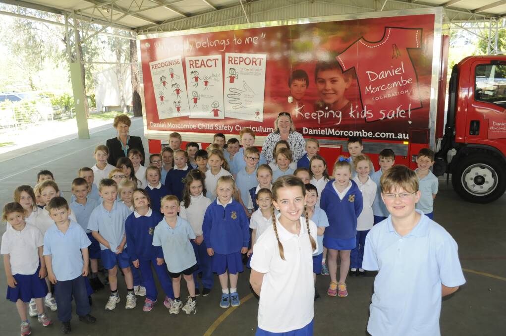STAY SAFE: Eglinton Public School captain Jane Sheather, vice captain Lachlan Taylor and kindergarten, Year 1 and Year 2 students with the Daniel Morcombe Foundation Big Red truck. Photo:CHRIS SEABROOK 102516cdaniel