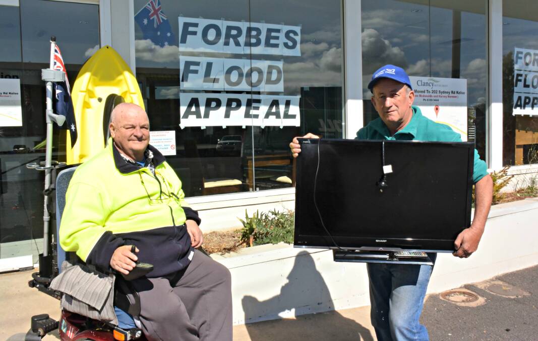 MAKE A BID: Bob Triming and Councillor Bobby Bourke with items for the auction. Photo: RACHEL FERRETT