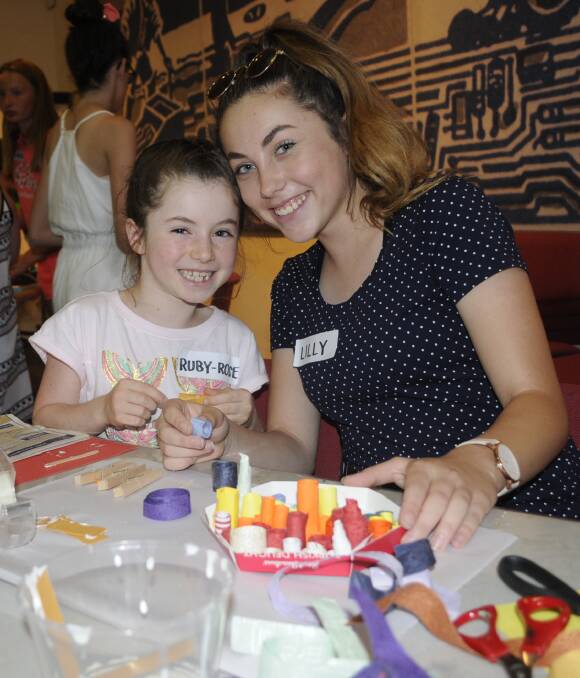 FUN: Sisters Ruby-Rose, 8, and Lilly Hamilton, 15, enjoyed themselves at the paper rolling workshop at Bathurst Regional Art Gallery. Photo: CHRIS SEABROOK 011917cbrag1