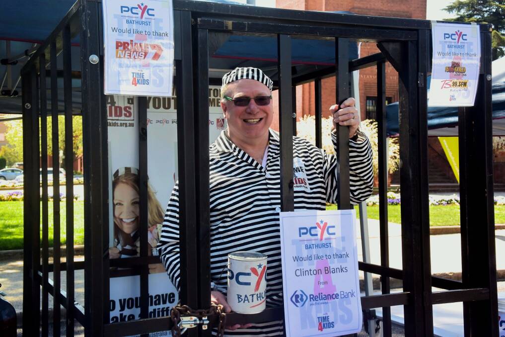 DOING TIME: Clinton Blanks from Reliance Bank was locked up for Bathurst PCYC's Time 4 Kids fundraiser. Photo: RACHEL CHAMBERLAIN 100417rcpcyc