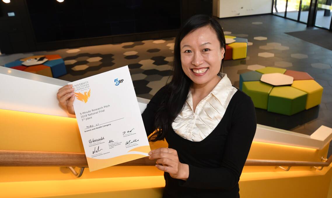 NATIONAL ACHIEVEMENT: Charle Sturt University civil engineering lecturer Dr Miao Li with her certificate. Photo: CHRIS SEABROOK 120418cmiao3