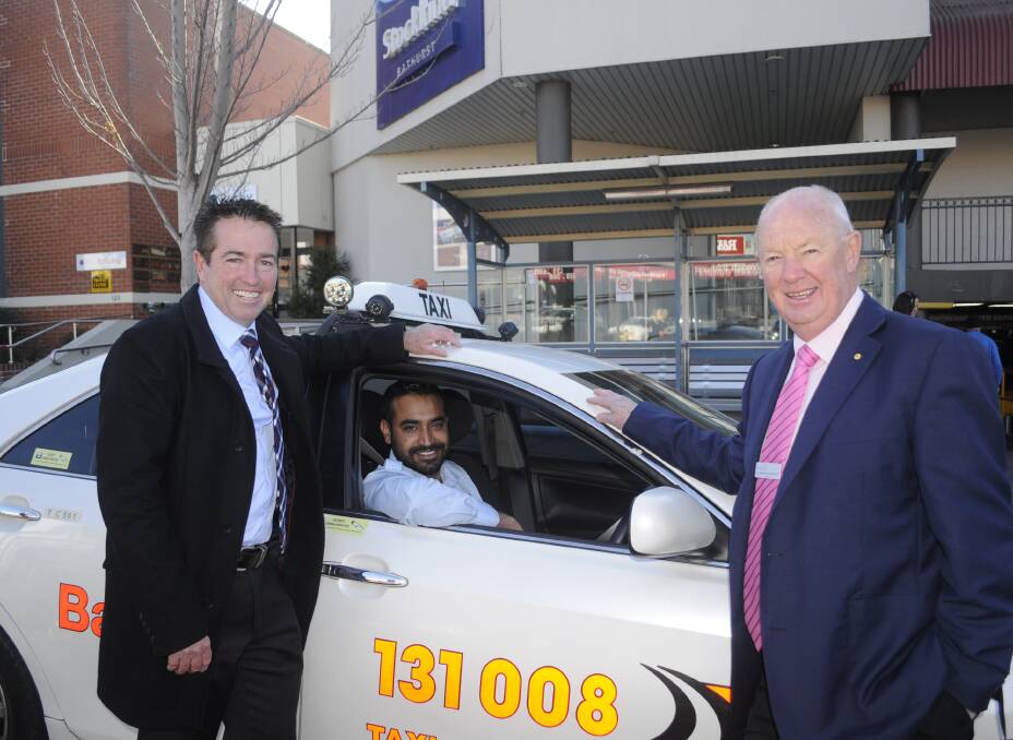 IMPROVEMENTS ON THE WAY: Member for Bathurst Paul Toole, Bathurst Taxis driver Arshdeep Nat and mayor Graeme Hanger by the taxi rank on Howick Street, where a $120,000 announcement of transport improvements was made. Photo: CHRIS SEABROOK 072517ctaxi1