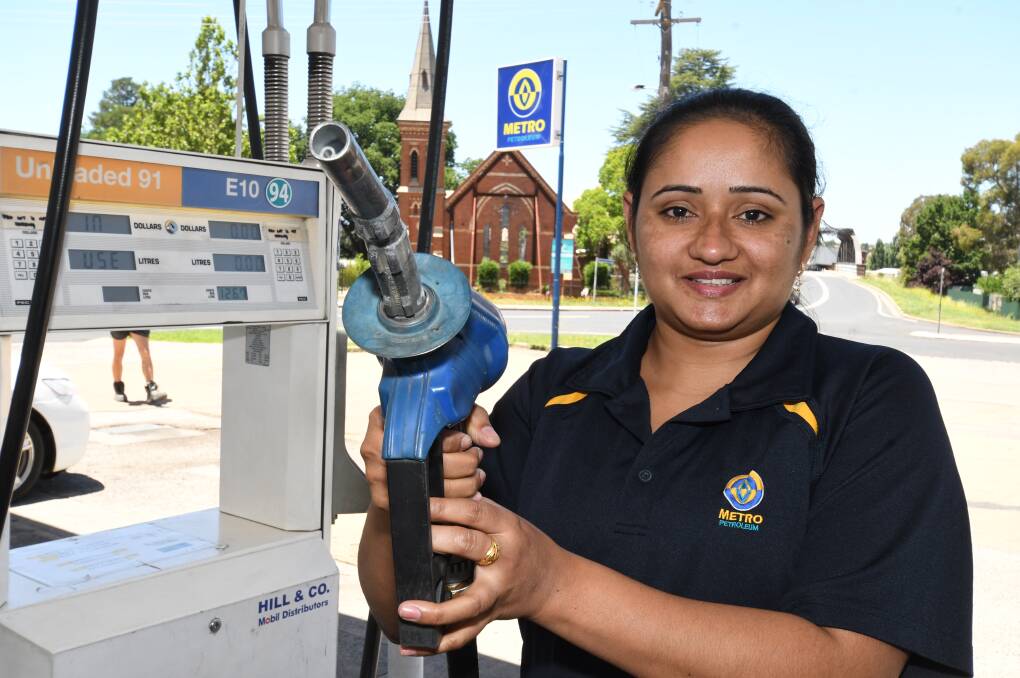 BEST DEAL AROUND: Metro Petroleum's Mani Kaur at the bowser ahead of the two days of discounts. Photo: CHRIS SEABROOK 121718cmetro1