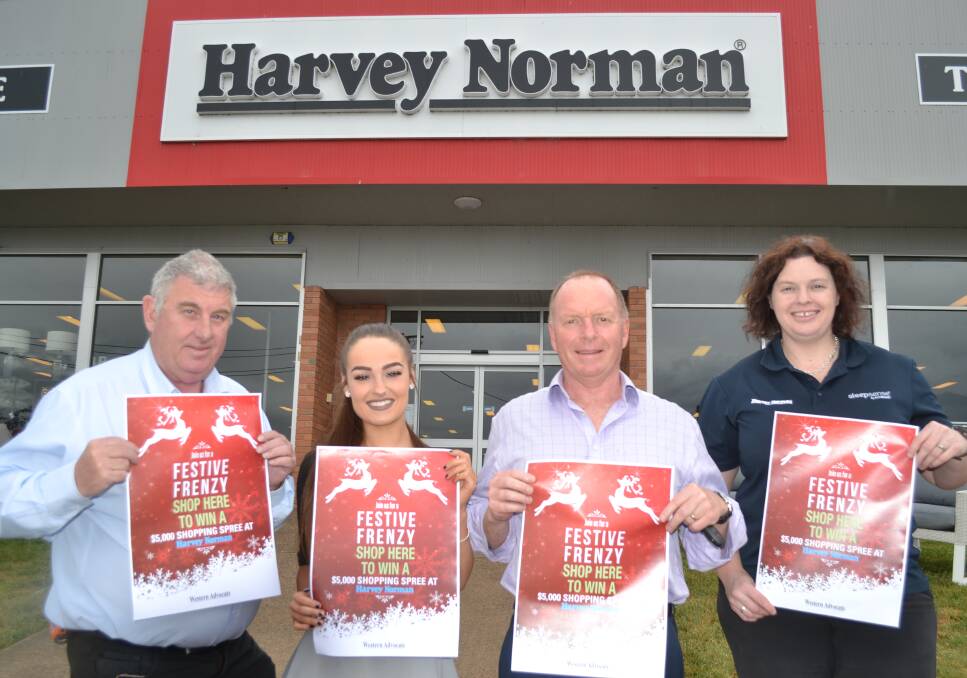 HOLIDAY SPIRIT: Harvey Norman's Dean Dillimore, Katie Robins and Abbie Miller with Western Advocate sales manager Nils Gustafson. Photo: MARTIN RUSSELL