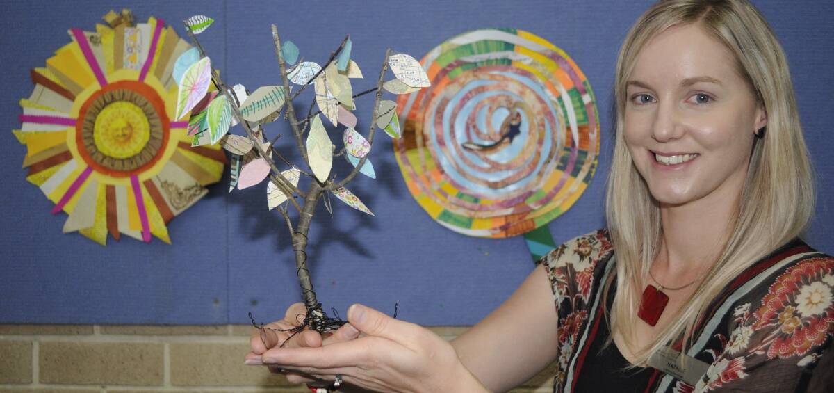 ACTIVITIES GALORE: Bathurst Library outreach programs officer Natalie Conn with examples of craft items children will make at the holiday workshops. Photo: CHRIS SEABROOK