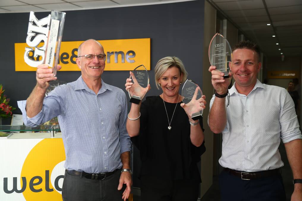 TOP PERFORMERS: Raine and Horne Bathurst principals Matt Clifton, Michelle Mackay and Grant Maskill-Dowton with the awards they won at the Raine and Horne NSW-ACT State Awards night. Photo: PHIL BLATCH 032118pbr&h1