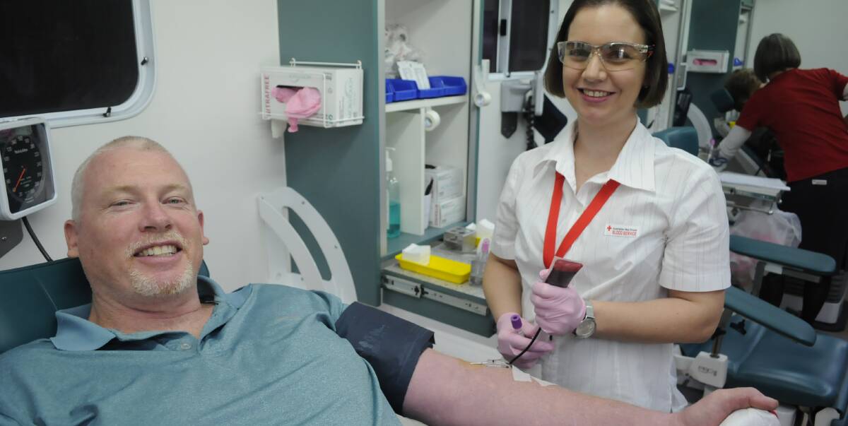 GIVING GENEROUSLY: Blood donor Eddie Costello gave his 25th donation with the help of registered nurse Liesa Pansina at the Red Cross Bathurst Mobile Donor Centre on Monday. Photo: CHRIS SEABROOK 072516cblood